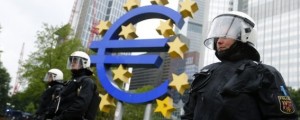 Riot police stand near the euro sign in front of the European Central Bank headquarters during an anti-capitalist "Blockupy" demonstration in Frankfurt