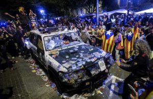 epa06217038 A view of damage to a Givil Guard vehicle as pro-independence demonstrators protest outside the regional Ministry of Economy's headquarters during a police search for documents connected with the organization of the Catalan independence referendum, in Barcelona, northeastern Spain, early 21 September 2017. Police forces arrested 14 people, including top officials of the Catalan Government and the Ministry of Economy's number two Josep Maria Jove Llado. The detentions provocked a mass reaction with thousands of pro-independence people taking the streets. EFE/Quique Garcia EPA/Quique García